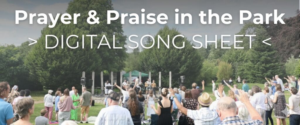 Prayer & Praise in the Park Printed Graphics (1920 x 540 px) Crowd standing outdoors in a park with raised hands and trees in the background, with the title Prayer and Praise in the Park and Digital Song Sheet shown over the image