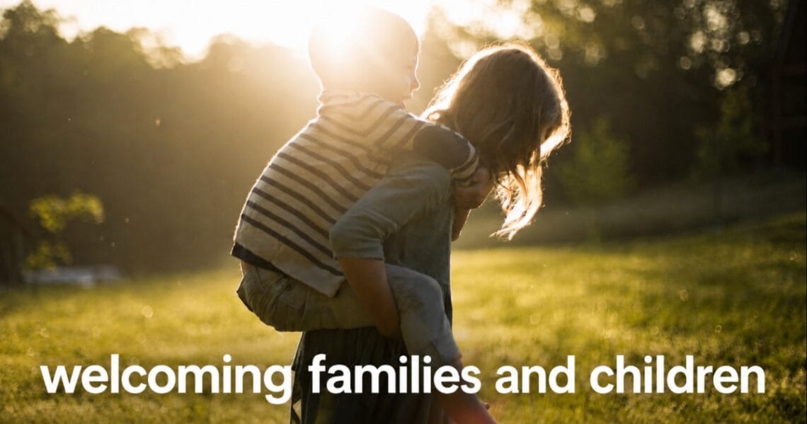 Woman carrying a child piggyback outdoors; text reads “welcoming families and children”