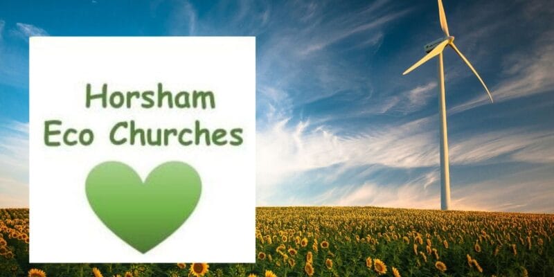 Horsham Eco Churches text with green heart beside a wind turbine in a sunflower field